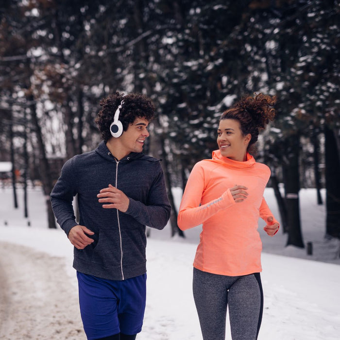 2 people running in the snow
