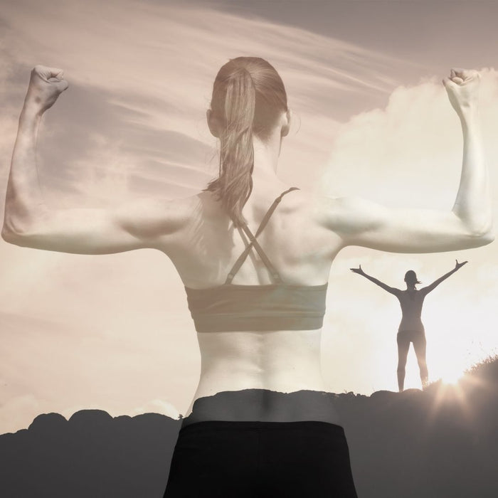 woman into fitness standing with arms up