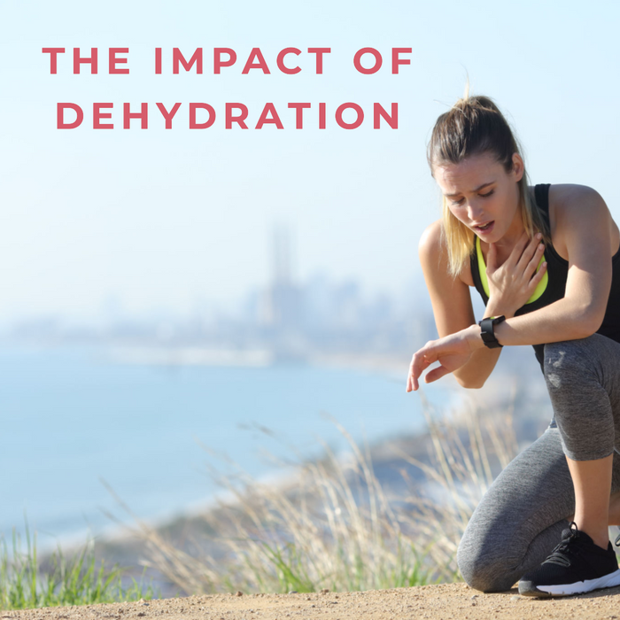 A female runner crouching since she is out of breath - The Impact Of Dehydration