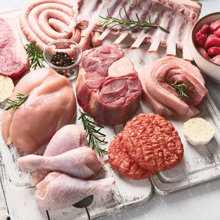 Two chopping boards with various raw meats