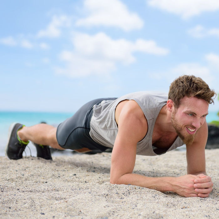 a man on the beach doing stomach toning exercises
