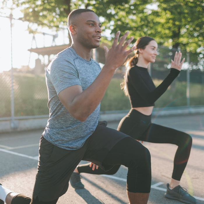 a mixed race couple exercising outside