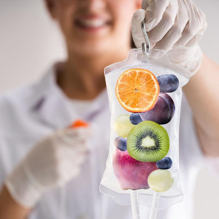 a nurse holding up a clear bag with pieces of fruit