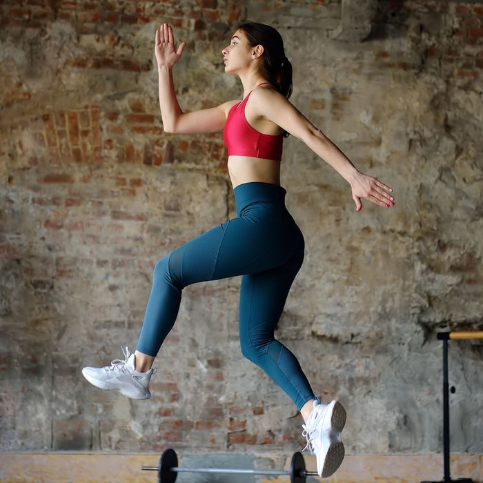 a woman jumping in the air doing hiit